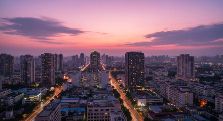 Vibrant city skyline glows at twilight with streaks of light from traffic below