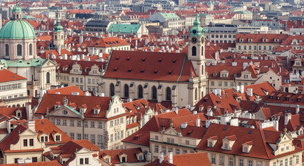 Obraz premium Charming European cityscape with red roofs and historic architecture under a clear sky