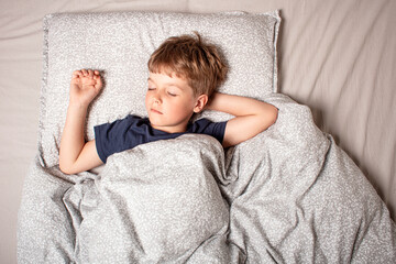 Healthy child, sweetest blonde,peaceful little boy sleeping in bed with eyes closed. Cozy, calm and...