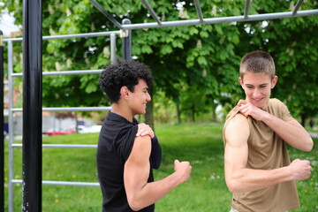 Two young male friends doing workout, active lifestyle, friendship concept