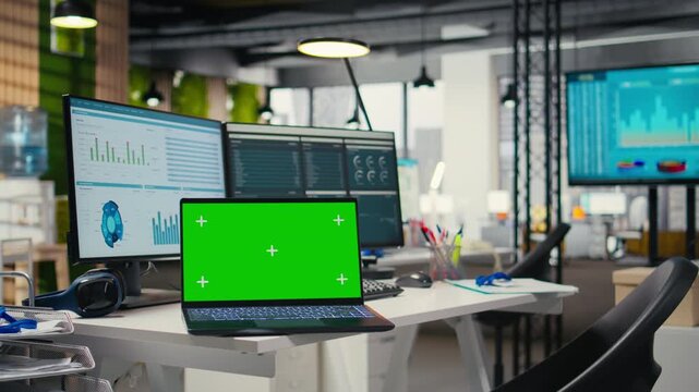 Empty company office features digital resources and mockup on laptop, workspace ready for report writing, strategy development and alignment of organizational goals achievement.