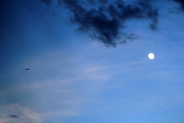 Light Airplane flying next to the moon