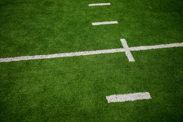 Football field green artificial turf with white lines and hash marks