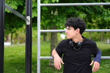 Young hispanic teenage guy portrait, stylish teenager outdoor