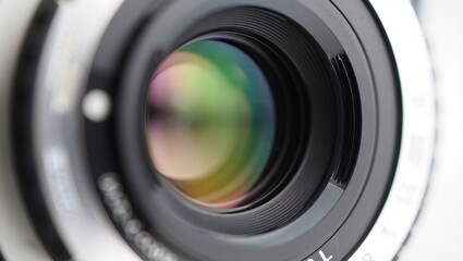 Close up of a camera lens with colorful light reflections