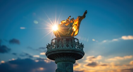 Golden torch of freedom against a radiant sunset sky, symbol of independence