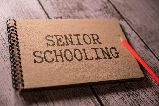 White card with the text Senior Schooling on study desk.
