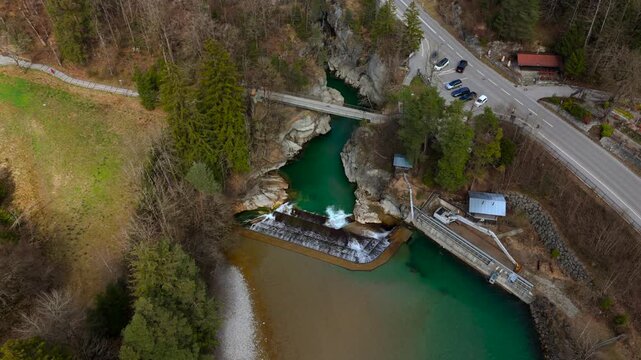 Lechfall, stunning waterfall in Fussen, Bavaria, captured from a high-angle drone shot. The scenic bridge, crystal-clear river, and picturesque landscape make it a perfect travel and photography spot