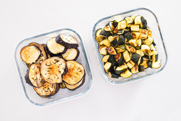 meal prep glass containers with roasted zucchini and eggplant slices