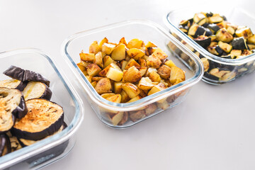meal prep glass containers with roasted potatoes zucchini and eggplant slices