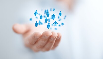 A hand holds a floating network of people icons