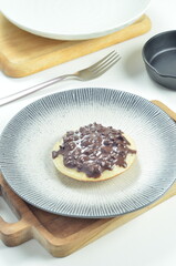 Serabi pancake with chocolate jam topping, a traditional Indonesian snack.