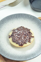 Serabi pancake with chocolate jam topping, a traditional Indonesian snack.