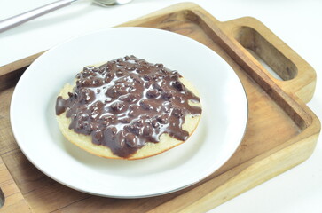 Serabi pancake with chocolate jam topping, a traditional Indonesian snack.