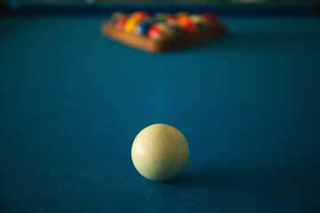 Billiard ball on blue table waiting for the game to begin