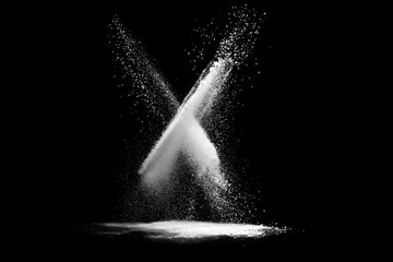 White powder explodes in an X shape against black