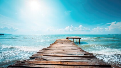 Sunny wooden pier extending into a turquoise ocean