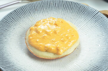 Serabi with cheese pasta topping, a traditional Indonesian snack.