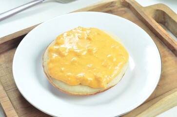 Serabi with cheese pasta topping, a traditional Indonesian snack.
