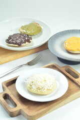 Serabi with grated cheese topping, a traditional Indonesian snack