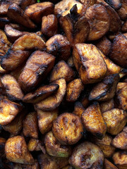 Close up of small cut pieces of fried plantains. Full frame of chunks sizes of fried plantain. Oily foods.