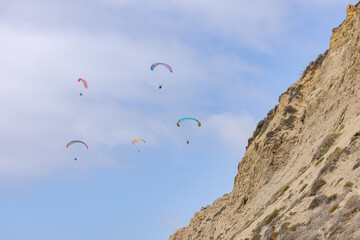 People paragliding over Black Beach La Jolla California 2025 