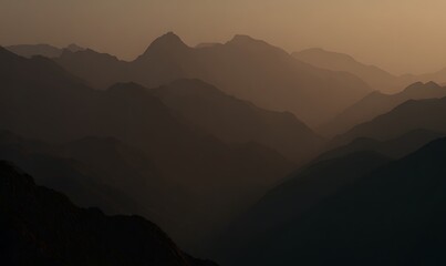 Fototapeta premium Misty mountain range at dusk evening