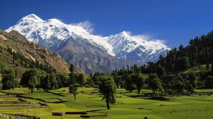 Majestic view of Nanga Parbat, the ninth-highest mountain in the world, featuring snow-capped peaks, steep rocky cliffs, glaciers, and swirling clouds in the Himalayas