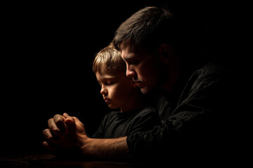 Father and Son Praying Together in Warm Light.