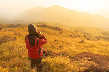 Lifestyle traveler happy feeling good relax and freedom facing in the sunrise morning. Travel Concept