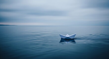 A serene image of a white paper boat floating on calm, blue water under an overcast sky. The scene evokes a sense of tranquility and minimalism.