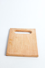 wooden cutting board with a handle cut out of one end, isolated on a white background.