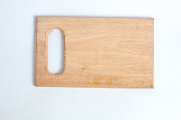 wooden cutting board with a handle cut out of one end, isolated on a white background.