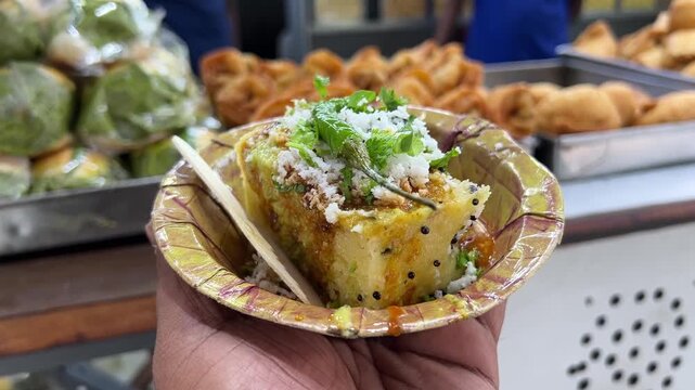 Dhokla served in front of Vada pav, pyaz kachori and spring roll. 