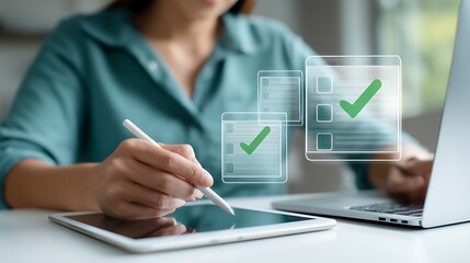 Woman completing digital checklist on tablet and laptop