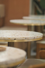 Round marble tables set for gathering at a cozy cafe