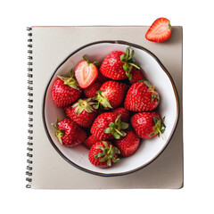 Fresh strawberries in a bowl on a notebook