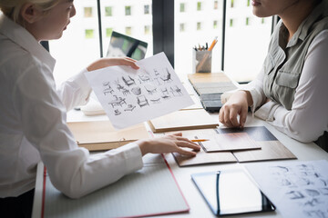 Interior designers brainstorming creative furniture design ideas in collaborative meeting