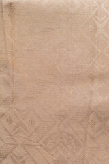 Close up view of brown cotton brocade fabric, texture of woven brown cotton fabric