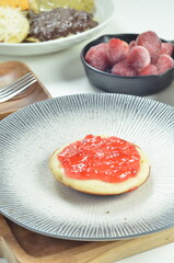 Serabi pancakes topped with strawberry jam, a traditional Indonesian snack