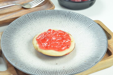 Serabi pancakes topped with strawberry jam, a traditional Indonesian snack
