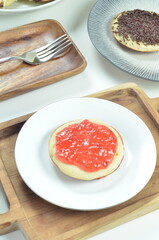 Serabi pancakes topped with strawberry jam, a traditional Indonesian snack