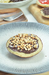 Serabi pancakes with chocolate and peanut butter toppings, a traditional Indonesian snack