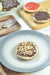 Serabi pancakes with chocolate and peanut butter toppings, a traditional Indonesian snack