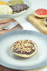 Serabi pancakes with chocolate and peanut butter toppings, a traditional Indonesian snack