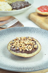 Serabi pancakes with chocolate and peanut butter toppings, a traditional Indonesian snack