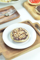 Serabi pancakes with chocolate and peanut butter toppings, a traditional Indonesian snack