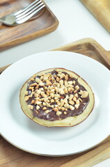 Serabi pancakes with chocolate and peanut butter toppings, a traditional Indonesian snack