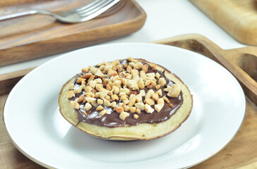 Serabi pancakes with chocolate and peanut butter toppings, a traditional Indonesian snack