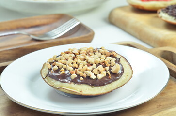 Serabi pancakes with chocolate and peanut butter toppings, a traditional Indonesian snack
